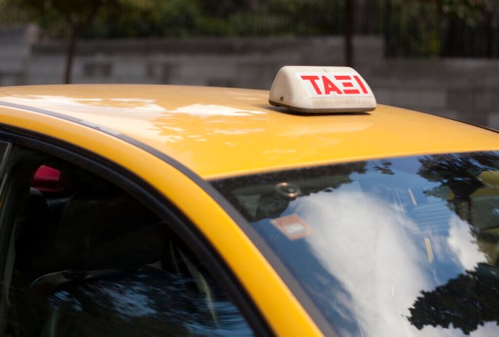 Taxi sign on yellow taxi in Athens, Greece.