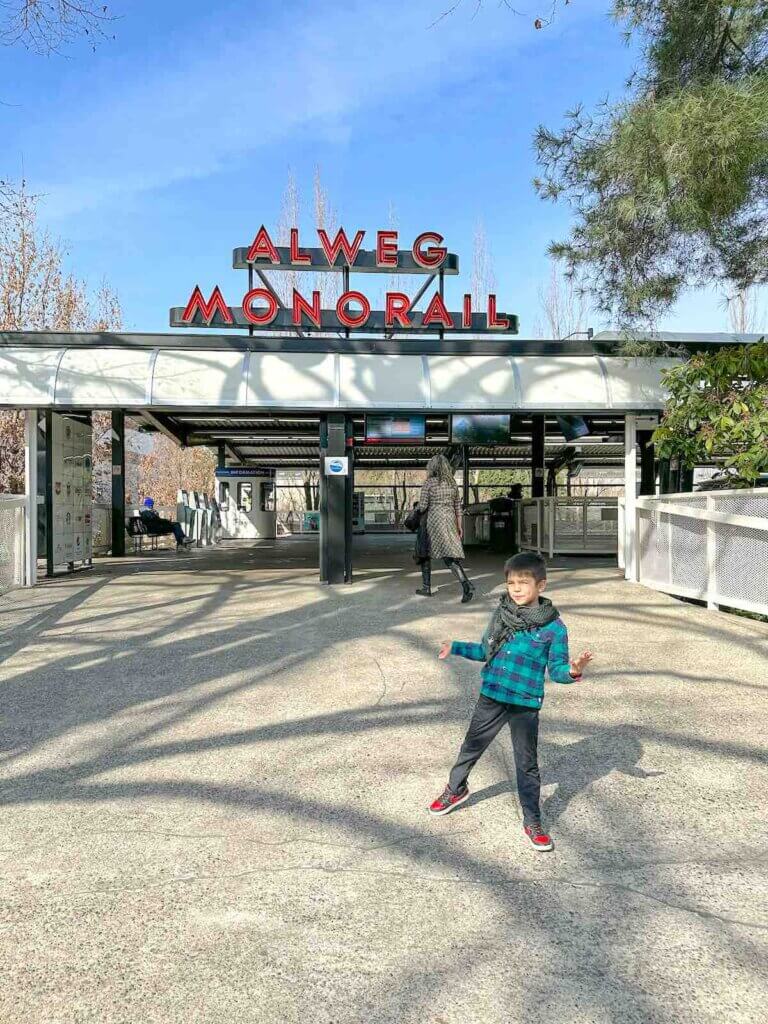 Image of a boy in front of the Seattle Center Monorail Station