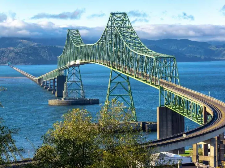 Find out how to spend a girls weekend in Astoria Oregon with tips by top family travel blog Marcie in Mommyland. Image of Beautiful view of the magnificent Astoria Megler Bridge crossing the Columbia River from Astoria, Oregon to Washington