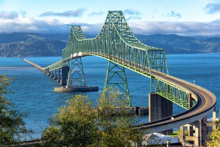 Find out how to spend a girls weekend in Astoria Oregon with tips by top family travel blog Marcie in Mommyland. Image of Beautiful view of the magnificent Astoria Megler Bridge crossing the Columbia River from Astoria, Oregon to Washington