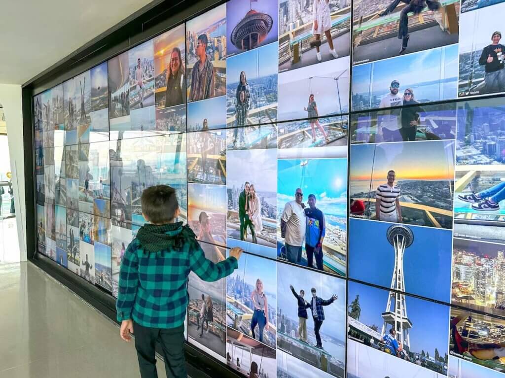 Image of a boy next to a digital photo wall at the Space Needle