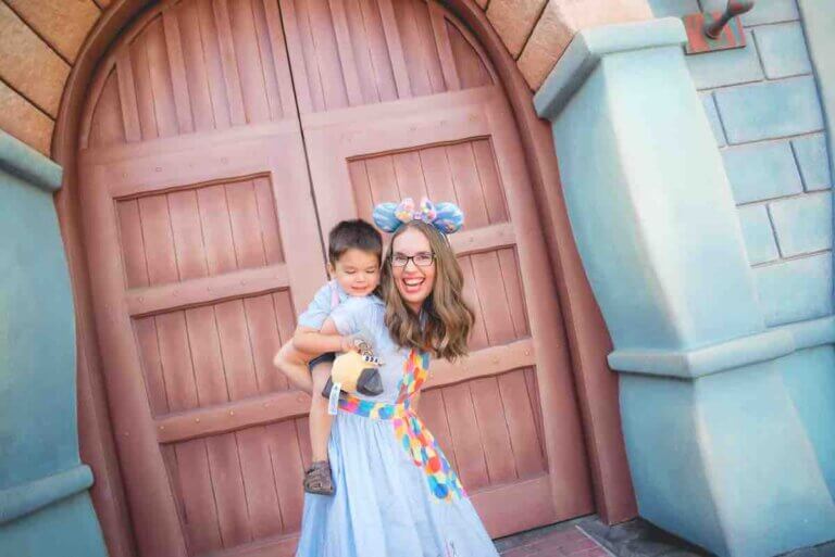 Check out these tips for visiting Disneyland with a 3 year old by top Disney blog Marcie in Mommyland. Image of a mom giving a piggyback ride to her son at Toontown in Disneyland