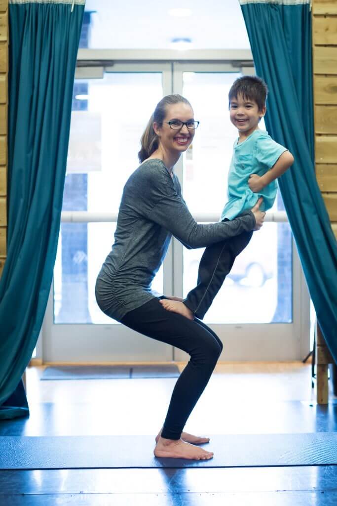 My son loved doing chair pose in this partner yoga for kids