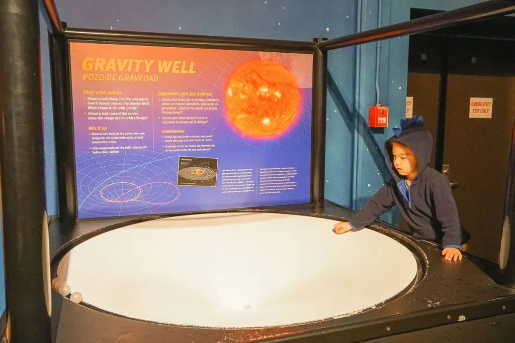 Photo of the Gravity Well at Pacific Science Center, which is a fun thing to do in Seattle with kids #pacificsciencecenter #pacsci #seattlecenter #STEM #seattle #seattlewa #familytravel