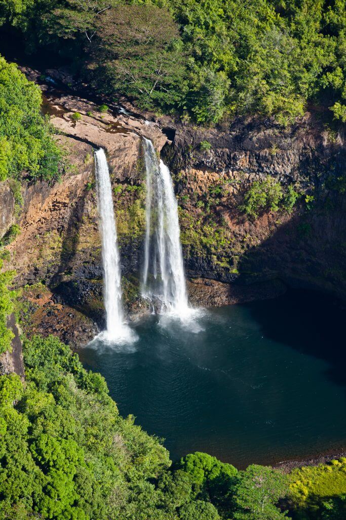 Photo of Wailua Falls, one of the best Kauai waterfalls and a top Kauai attraction #wailuafalls #wailua #kauai #waterfall #hawaii #familytravel