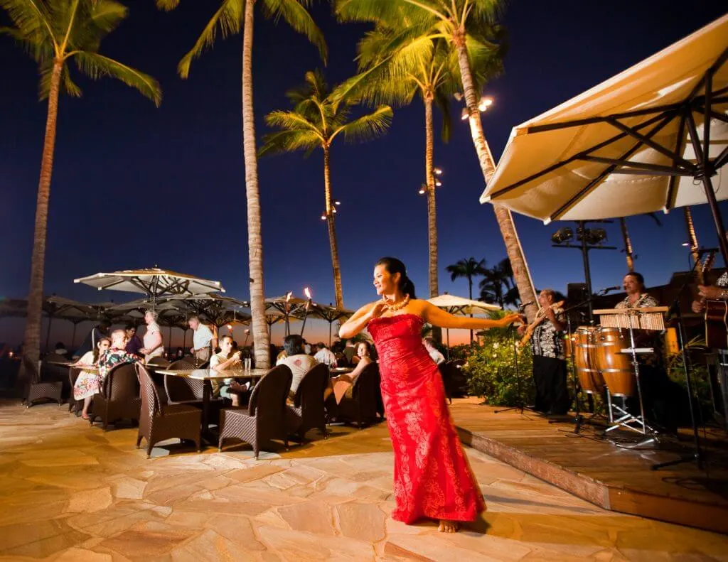 Photo of a woman dancing hula at a Waikiki restaurant, which is a cheap thing to do on Oahu #hula #waikiki #oahu #hawaii