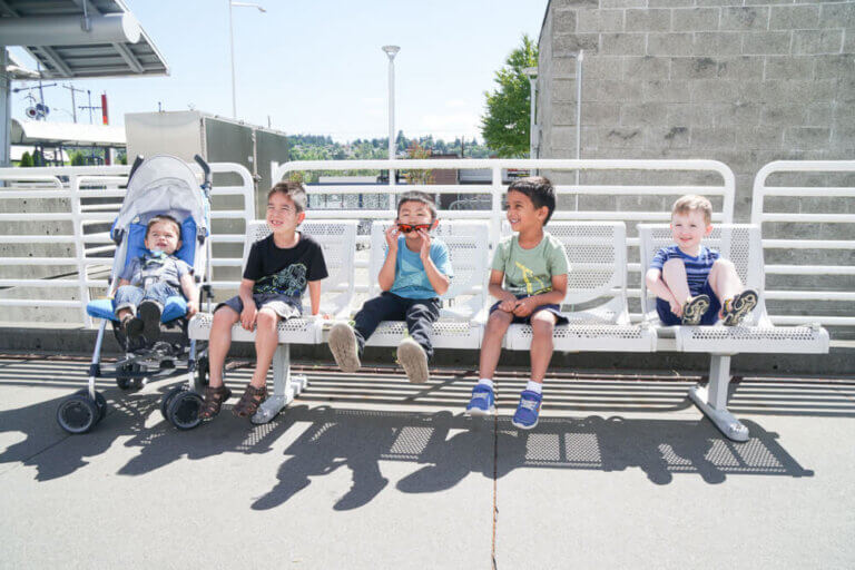 Photo of kids waiting for the Sounder train at Kent Station to King Street Station in Seattle, as part of a Seattle play date #sounder #soundtransit #kentwa #visitkent #train #seattle #seattlewa #seattleplaydate #seattlekids #seattlefamily