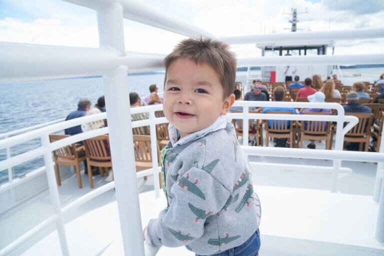 Photo of a toddler on the Argosy Cruises ship to Tillicum Village on Blake Island near Seattle, WA #argosycruises #blakeisland #tillicumvillage #seattle #seattlewa #pnw #pacificnorthwest #boat #seattlecruise