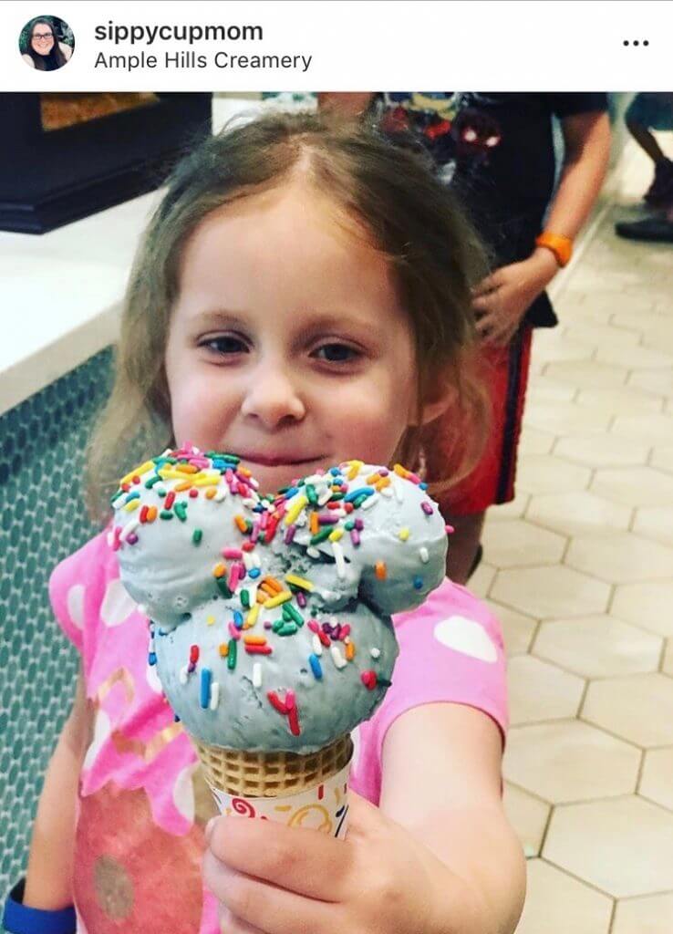 Photo of a girl receiving a Mickey ice cream cone as part of a Cast Member's Disney pixie dust magic! #disney #disneysmmc #mickeyicecream #mickeytreats