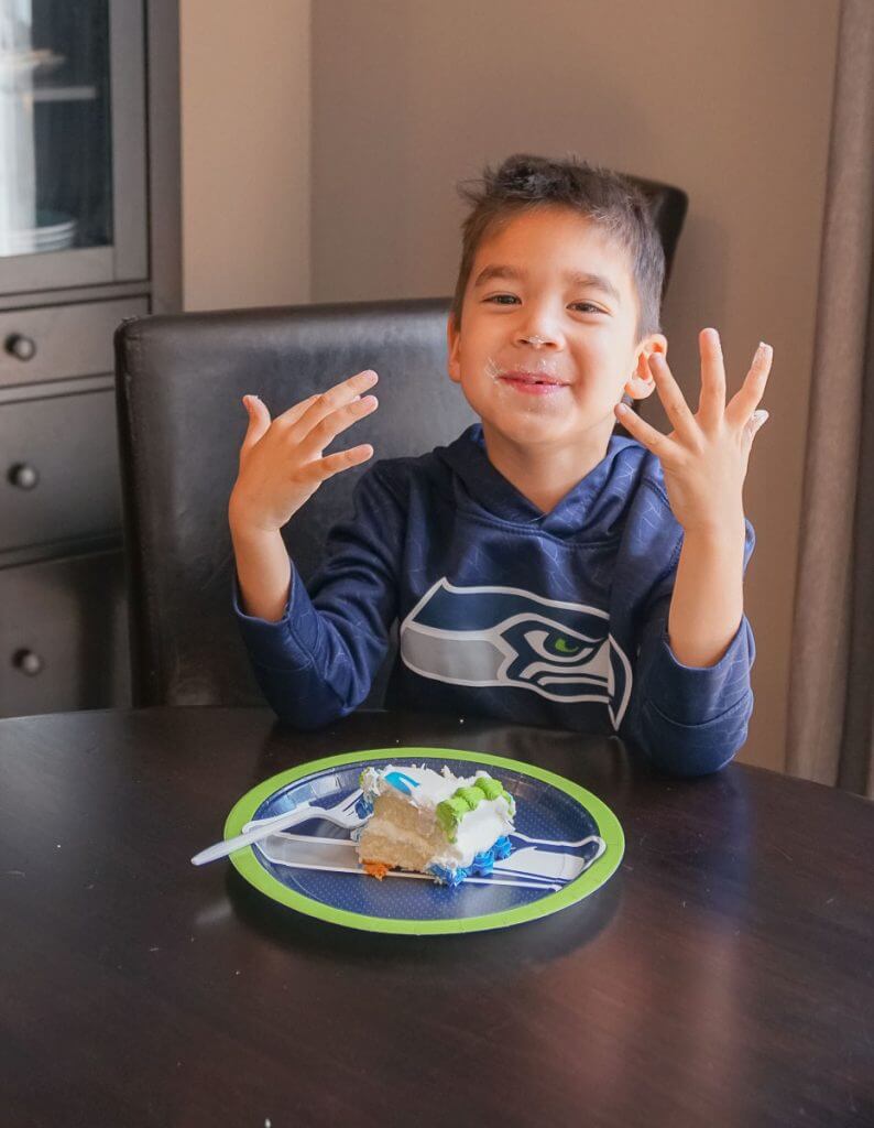 Photo of a boy eating a Seahawks cake for a football themed party #nfl #seahawks #seattleseahawks #seahawksparty
