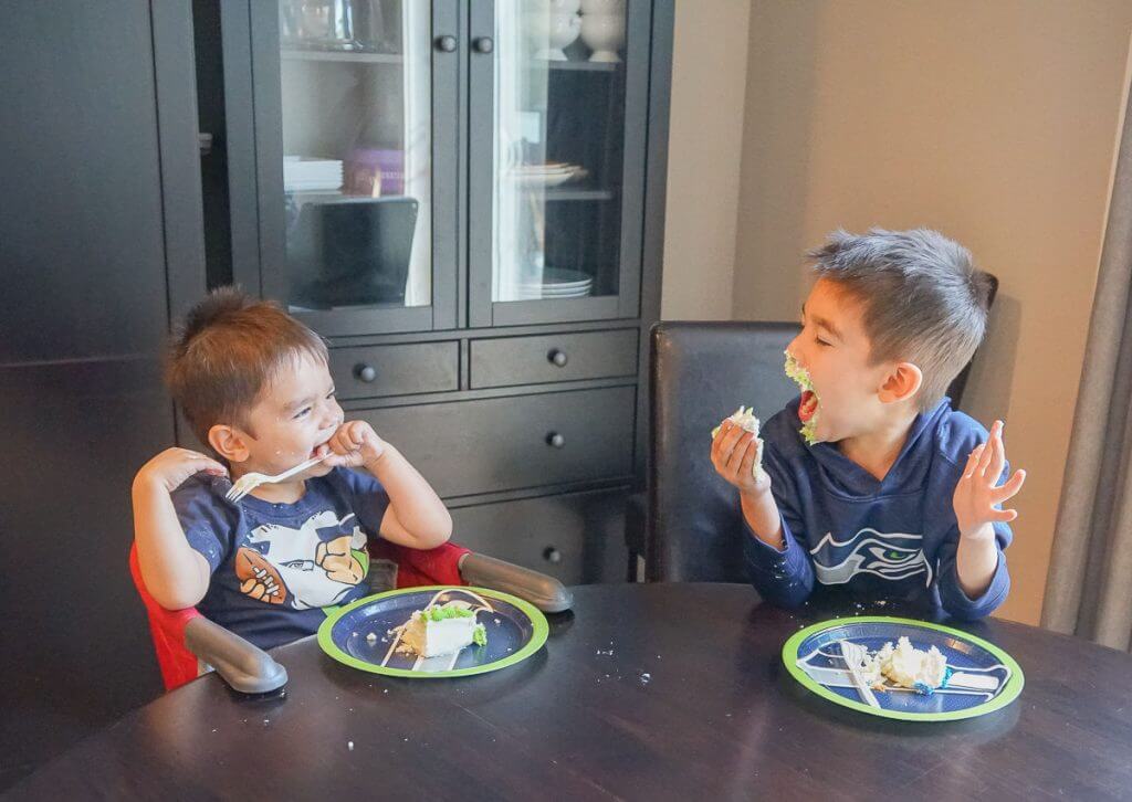 Photo of kids eating a Seattle Seahawks cake at a football party #seattleseahawks #seahawks #footballparty #footballcake #nflcake #decopac