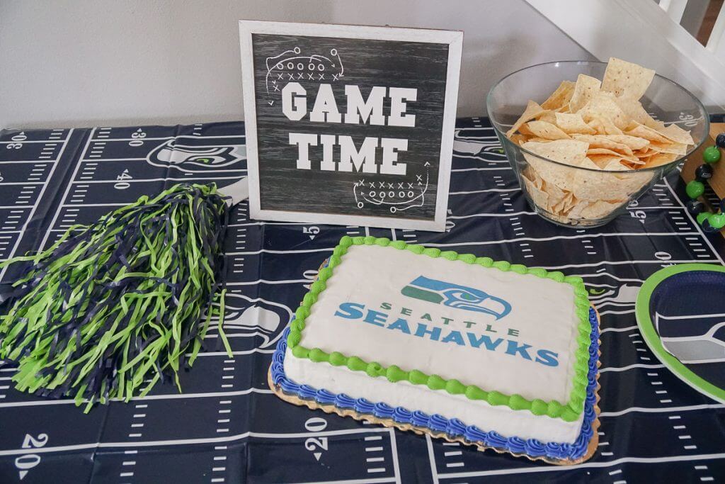 Photo of a Seattle Seahawks party table with an officially licensed NFL cake from DecoPac #decopac #seattleseahawks #nfl #nflcake #seahawks