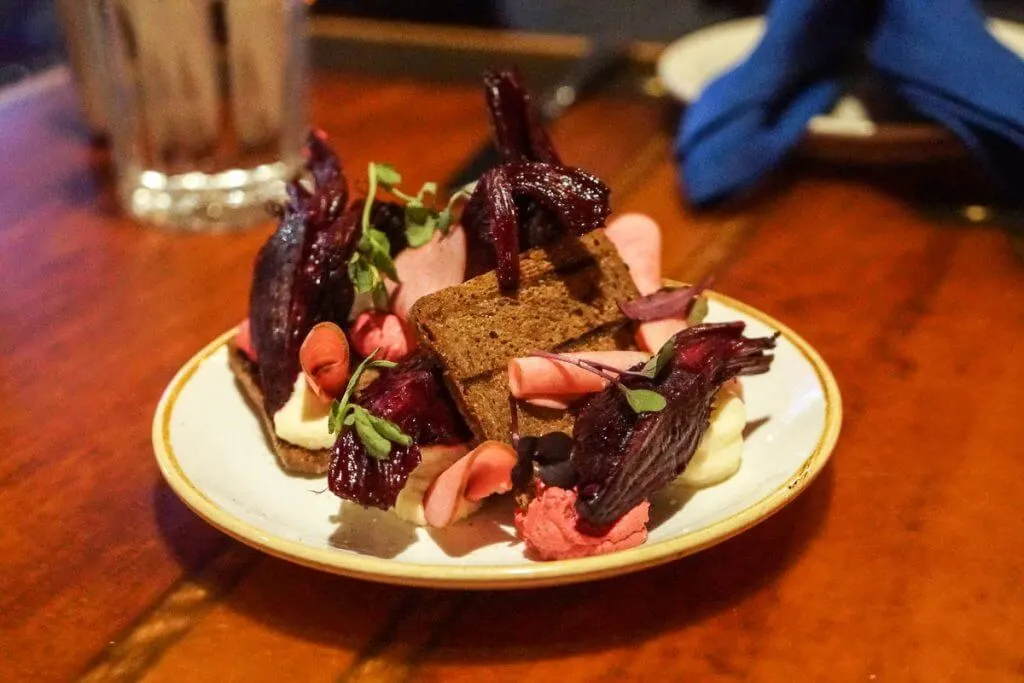 The goat cheese beet tartine at Fisherman's Restaurant & Bar in Seattle is a standout appetizer, perfect for a romantic Seattle date.