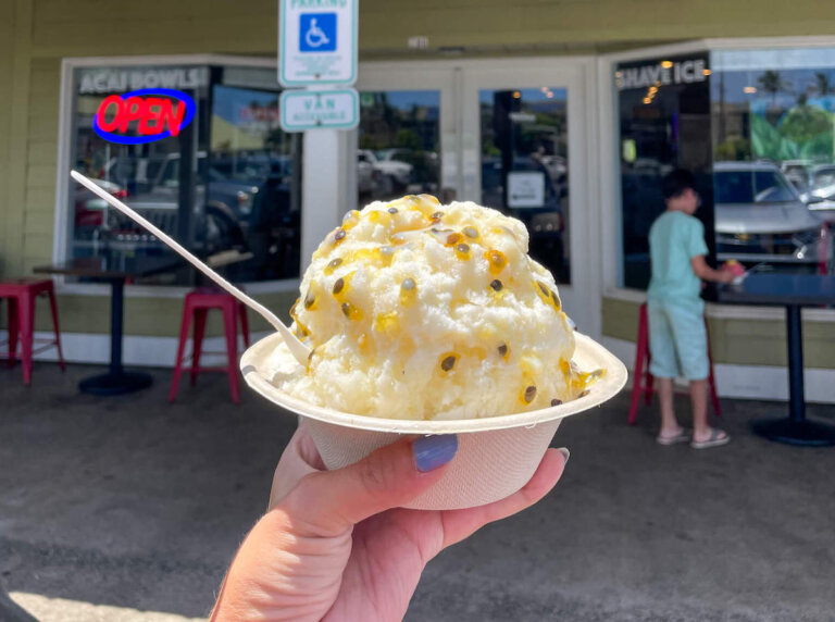 Check out this list of the best shave ice in Kauai recommended by top family travel blog Marcie in Mommyland. Image of a bowl of shave ice on kauai