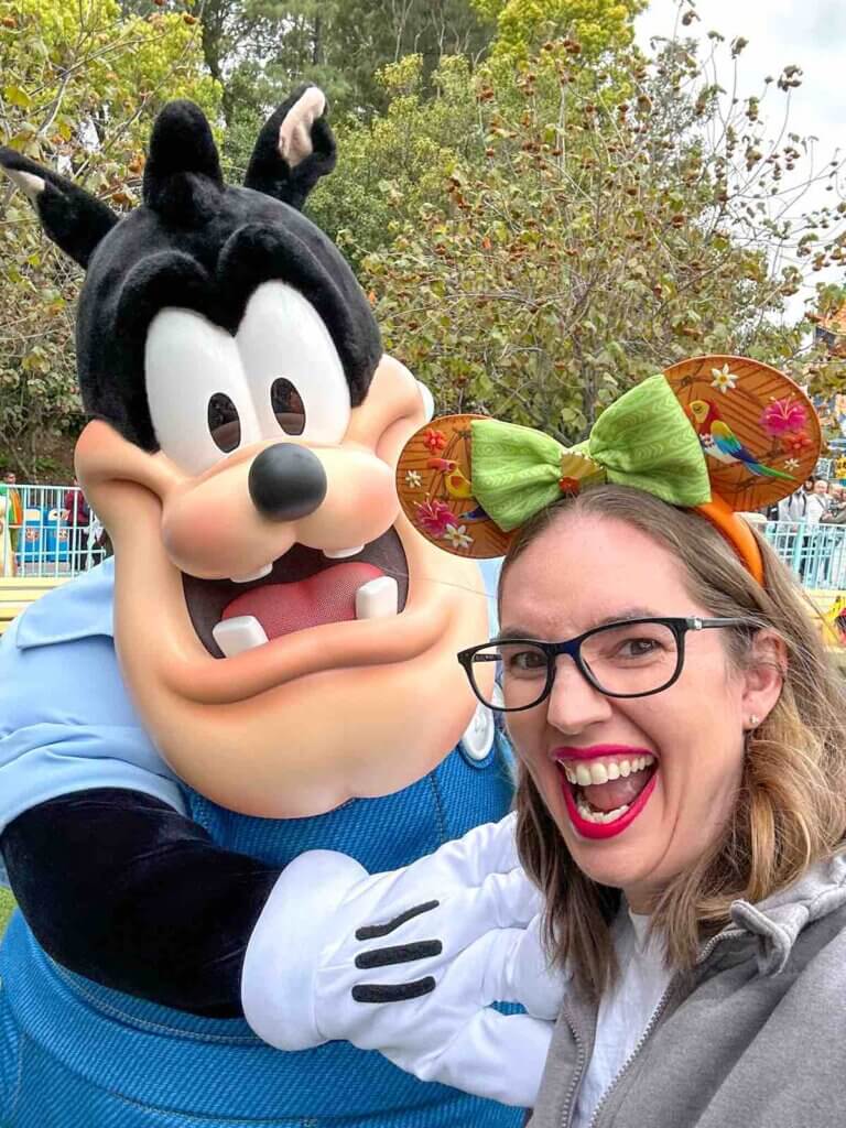 Image of a woman taking a selfie with Disney character Pete