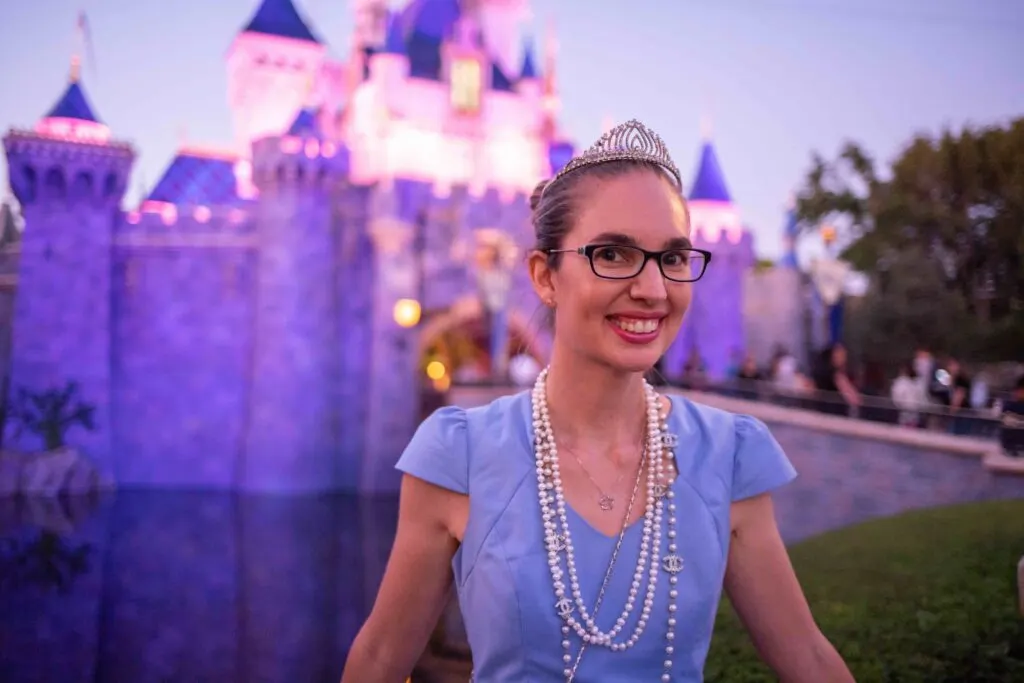 Image of a woman wearing a blue dress, pearls, and a tiara