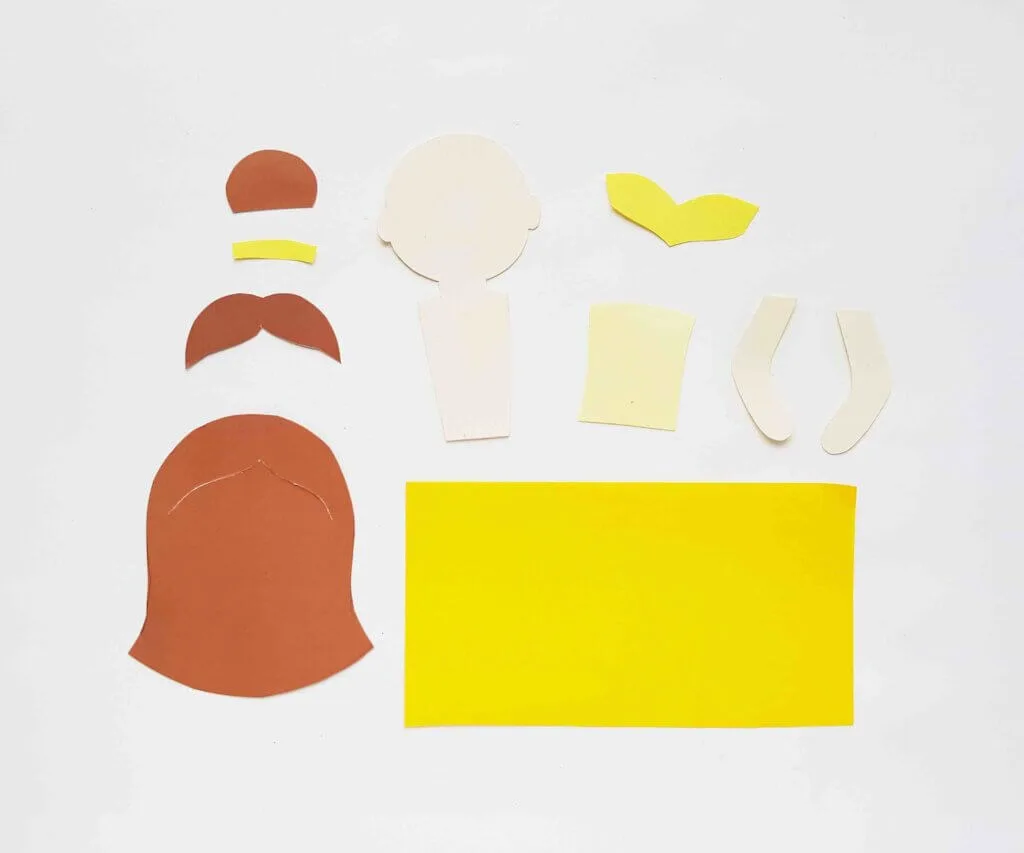 Image of colorful paper cut out for pieces of a Belle paper doll