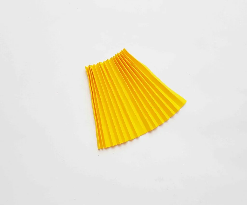 Image of a yellow accordion folded skirt