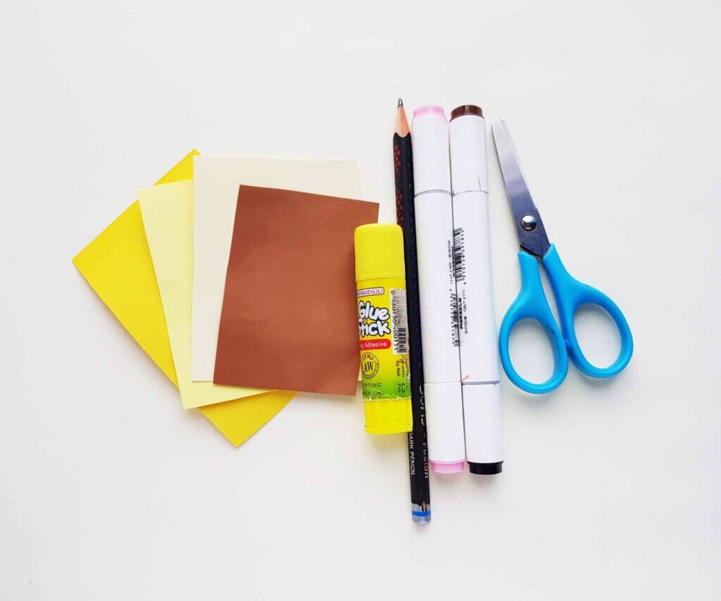 Image of scissors, glue stick, paper, and markers