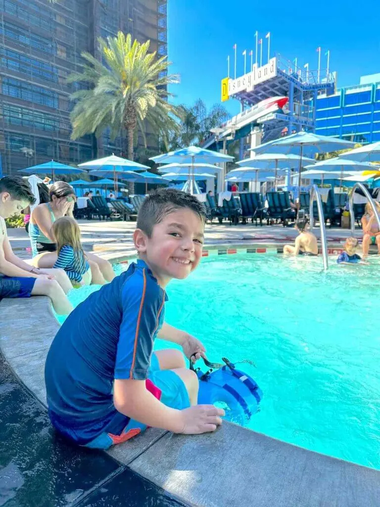 Image of a boy with his legs in the hot tub at the Disneyland Hotel.