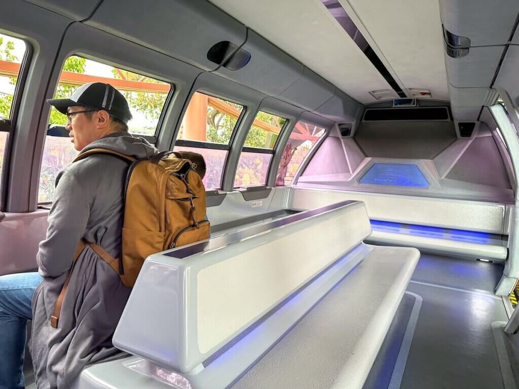 Image of a man with a backpack on the Disneyland Monorail