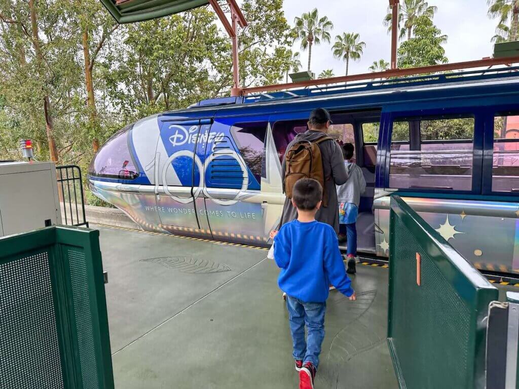 Image of a boy boarding the Disneyland Monorail