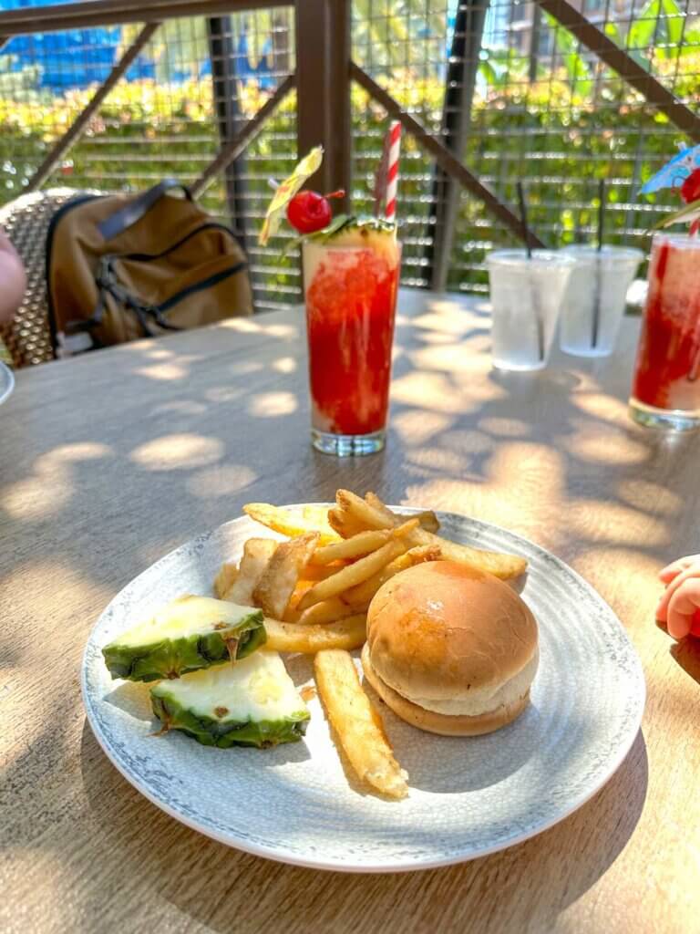 Image of tropical drinks and a kids meal at Trader Sam's at the Disneyland Hotel