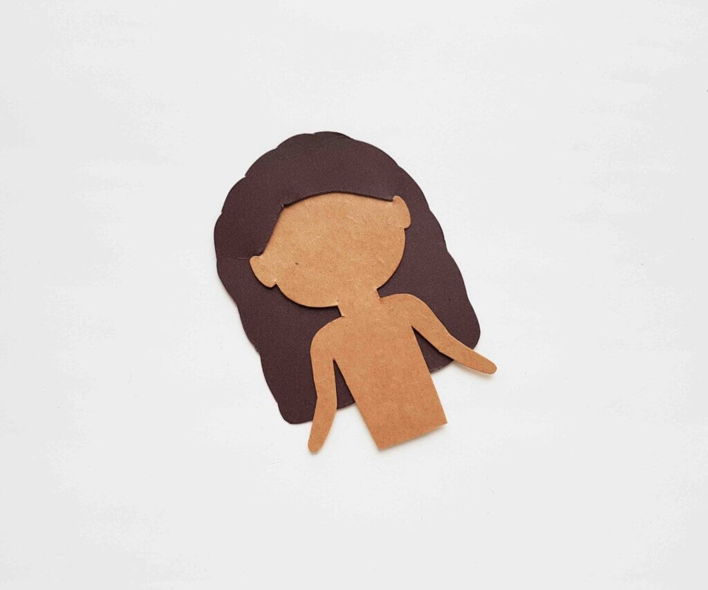 Image of a brown paper doll body and hair