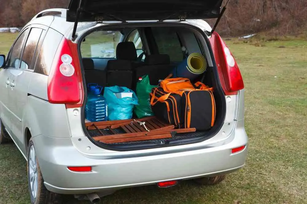 10 Best Secret Places to Hide Christmas Presents featured by top US lifestyle blogger, Marcie in Mommyland: You can hide Christmas presents in your car. Image of hatchback car loaded with open trunk and luggage
