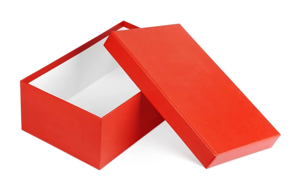 How to Store Christmas Ornaments So They Won't Break, tips featured by top Seattle lifestyle blogger, Marcie in Mommyland: Shoe boxes are perfect for storing Christmas ornaments. Image of Open red shoe box isolated on white with clipping path