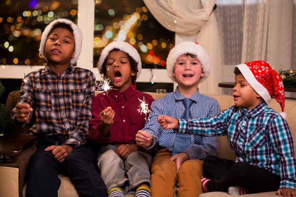 10 Festive Ways to Countdown til Christmas + FREE Christmas Countdown Printable featured by top Seattle lifestyle blogger, Marcie in Mommyland: Singing Christmas carols is a fun Christmas countdown idea. Image of Kids singing Christmas song. Four children sing Christmas song. Shall we sing. Gentlemen respect traditions.