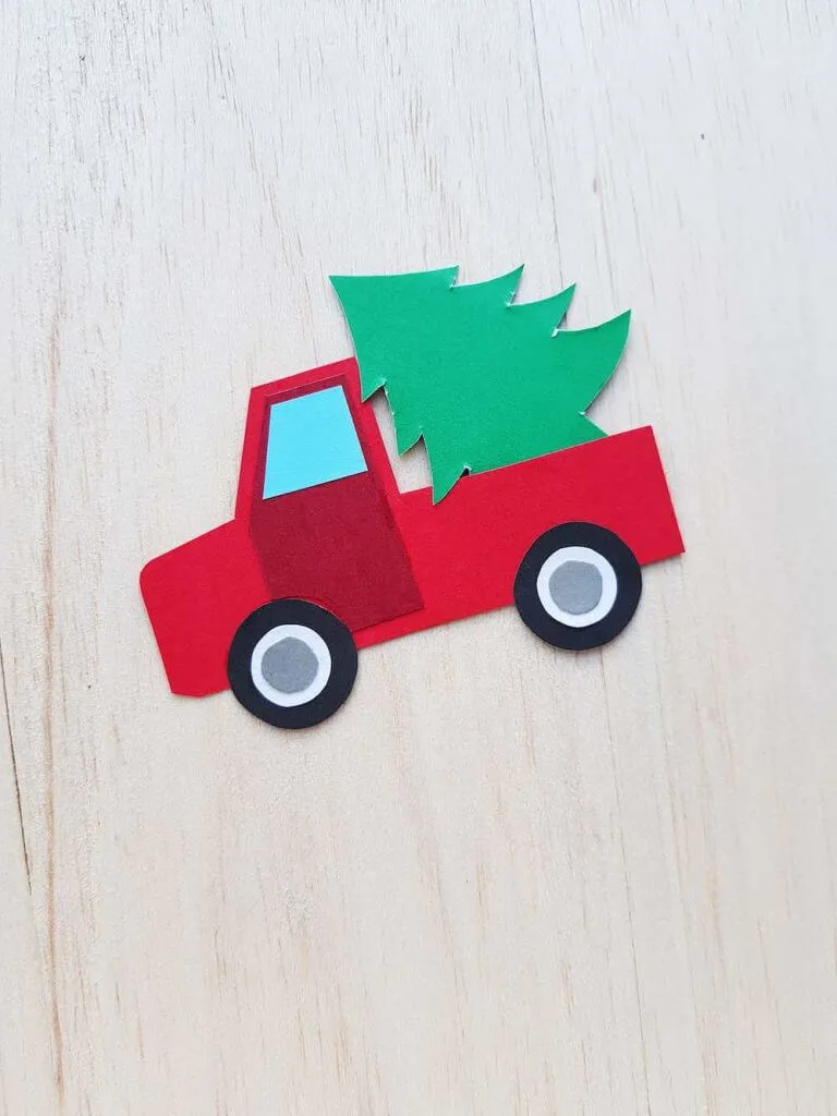Best Christmas Paper Crafts featured by top Seattle lifestyle blogger, Marcie in Mommyland: Red Truck with Christmas Tree Step 8. Image of completed Christmas Truck Paper Craft