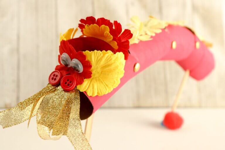 Find out how to make this Chinese New Year Dragon Craft by top Seattle lifestyle blog Marcie in Mommyland. Image of a cardboard tube dragon craft for Chinese New Year