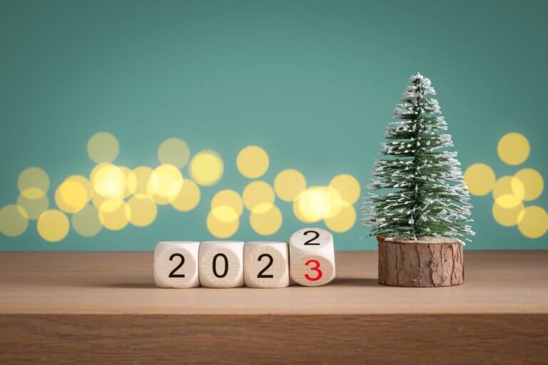 Find out easy New Years Eve Ideas for Families in this post by top Seattle lifestyle blog Marcie in Mommyland. Image of a Christmas tree and block numbers 2023