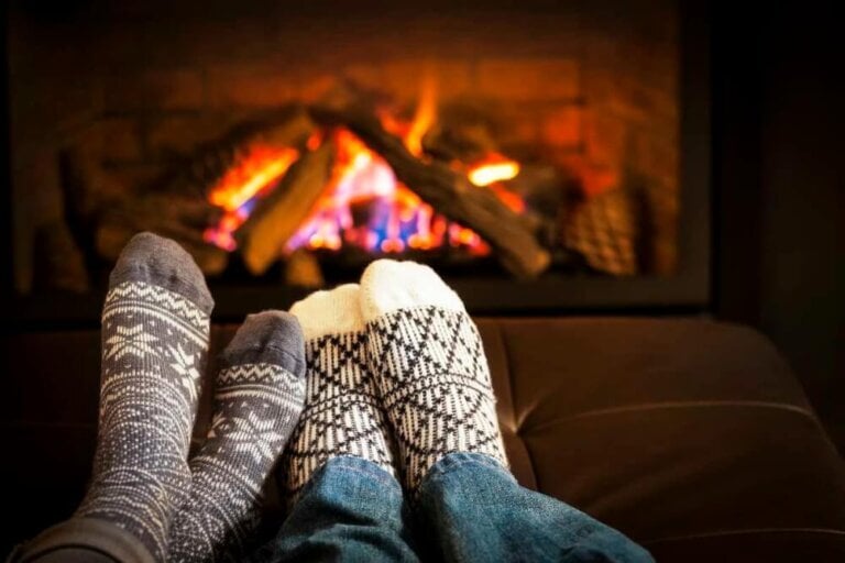 Find out how to save money this winter with these cold weather hacks.Image of: Feet in wool socks warming by cozy fire