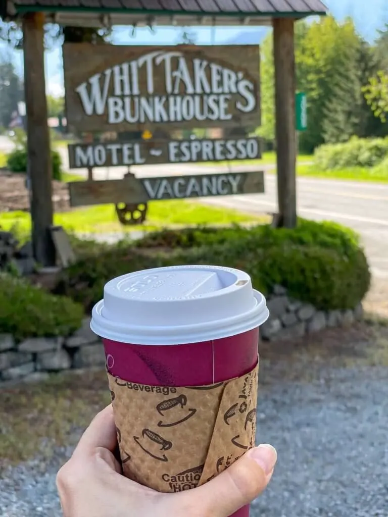 Looking for coffee near Mt Rainier? Whittaker's Bunkhouse has a really nice coffee shop. Image of someone holding a coffee cup.