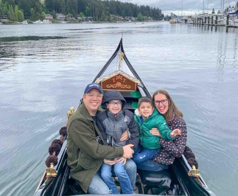 Find out how to ride a Gig Harbor Gondola in Washington State by top Seattle blog Marcie in Mommyland. Image of a family sitting in a gondola at Gig Harbor Washington.