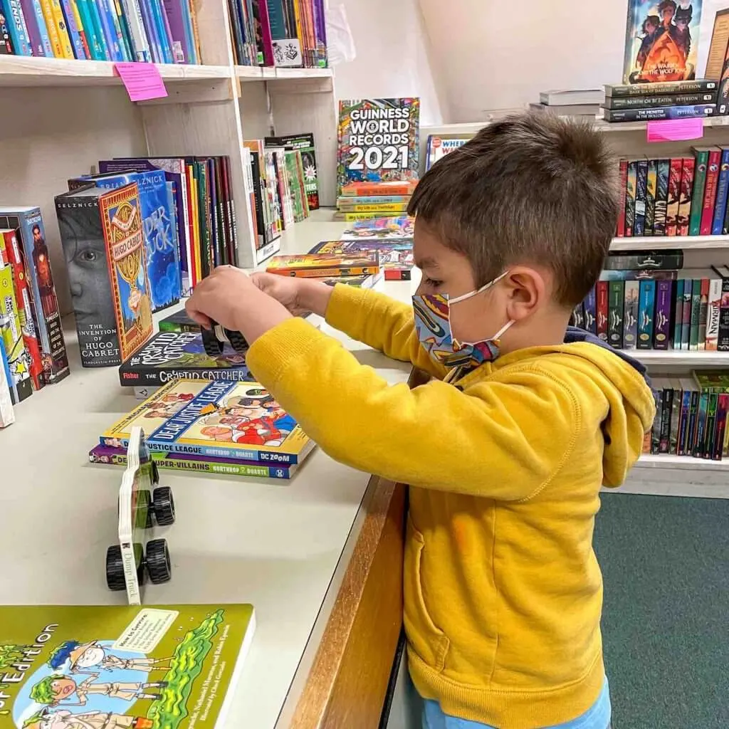 We love supporting independent book stores when we travel. Image of a boy looking at books at A Good Book in Sumner WA.