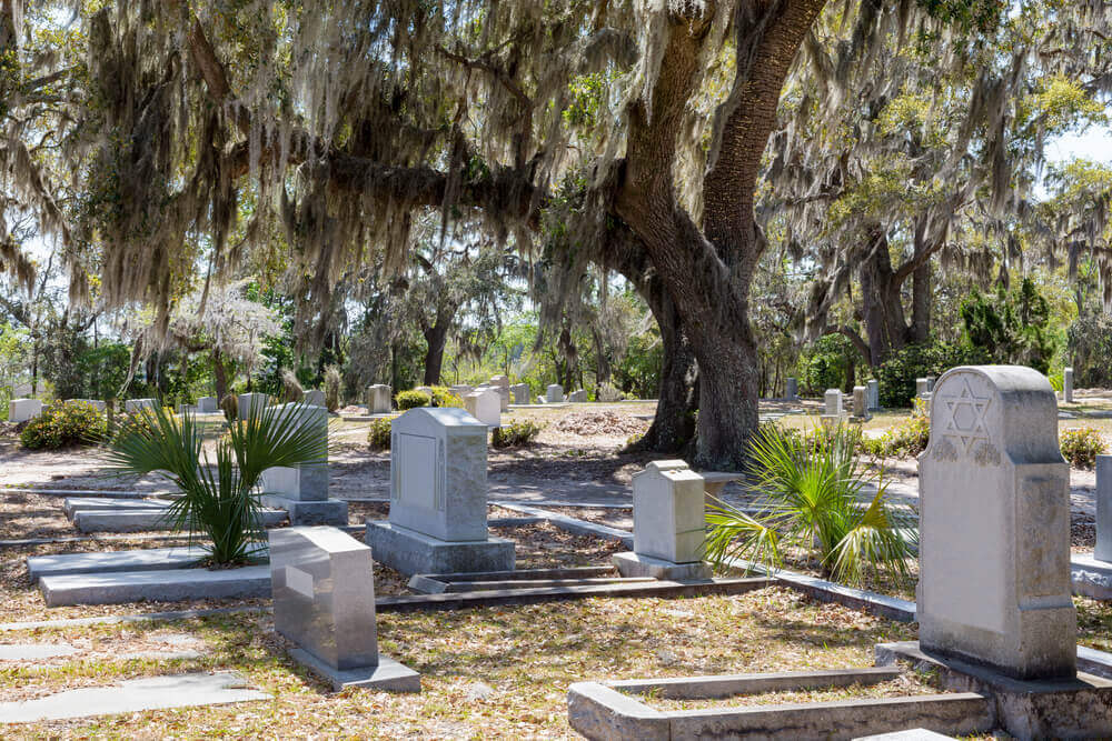 The Historic Bonaventure Cemetery in Savannah Georgia is one of the best places to go on Halloween. Image of a historic cemetery during the day.