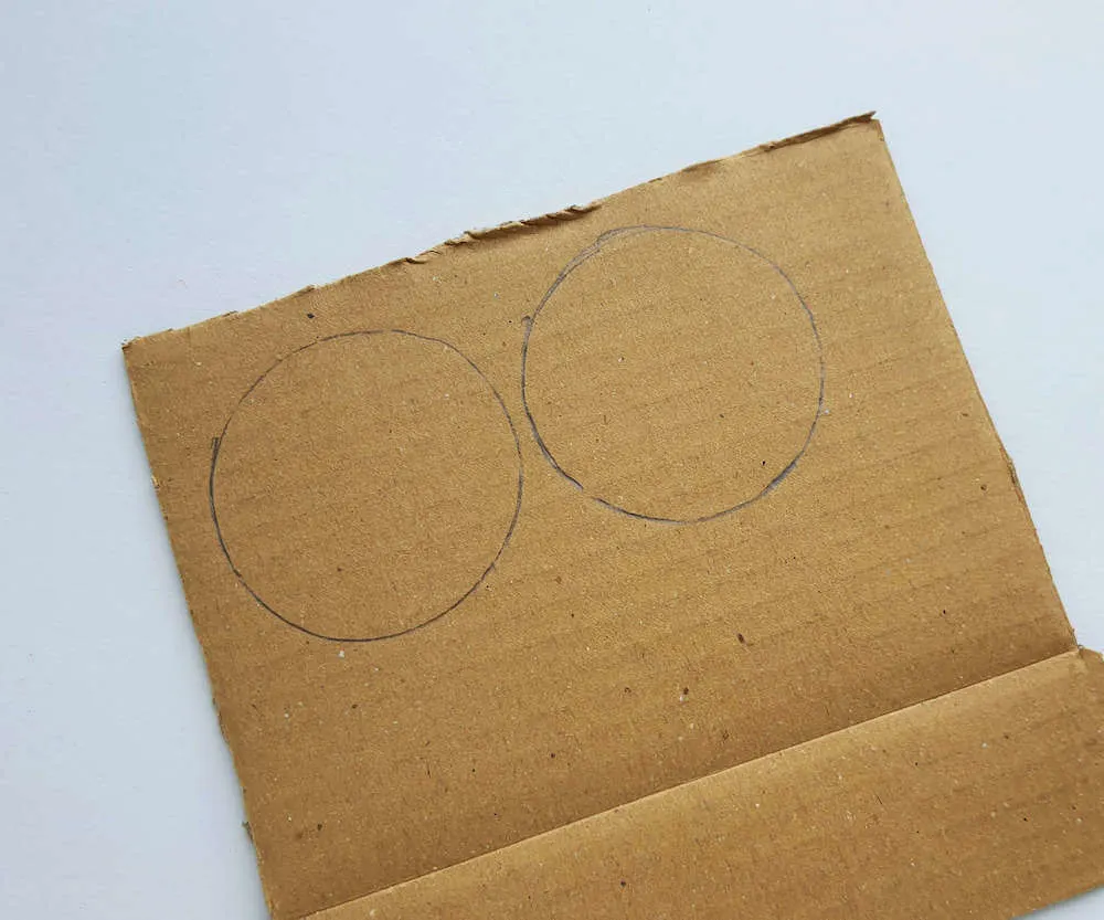 The first step for this Native American craft for kids is to trace circles onto cardboard.