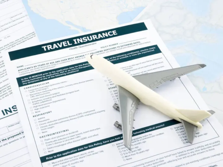 Find out whether or not you need Hawaii travel insurance by top Seattle blogger Marcie in Mommyland. Image of a toy airplane and travel insurance paperwork.
