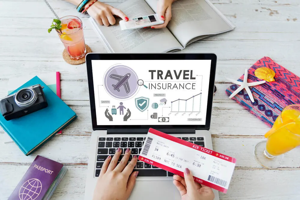 Find out the pros and cons of investing in Hawaii travel insurance for your next Hawaiian vacation. Image of a laptop with travel insurance on the screen.
