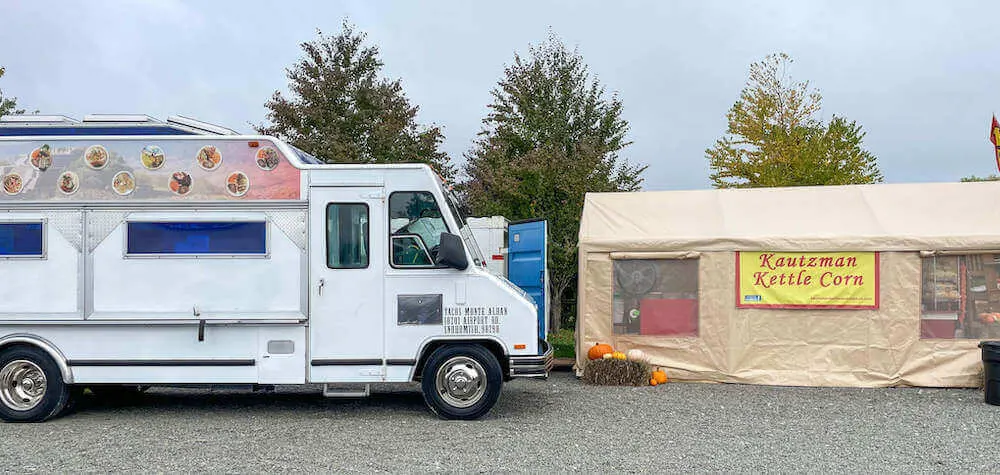 Image of a taco truck and kettle corn tent.