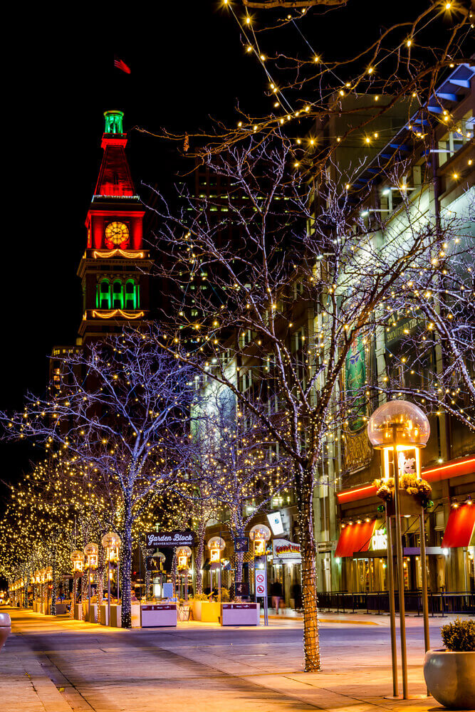 Denver Colorado is one of the best Christmas towns in the United States. Image of a street with Christmas lights and decorations at night.
