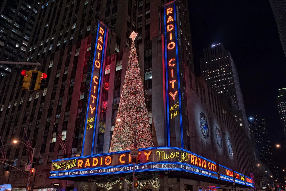 It's hard to beat Christmas in New York City! Image of Radio City Music Hall with a big Christmas tree.