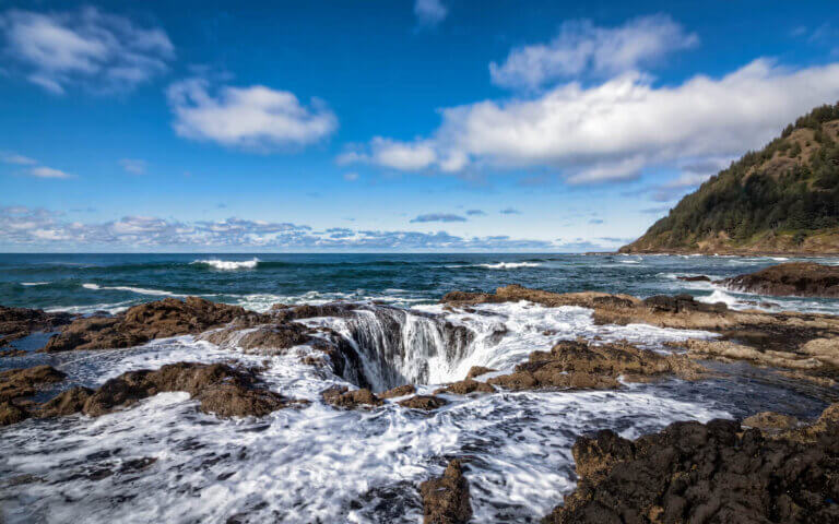 Find out the most unique places to visit in Oregon recommended by top Seattle blog Marcie in Mommyland. Image of Thor's Well sinkhole in Oregon.