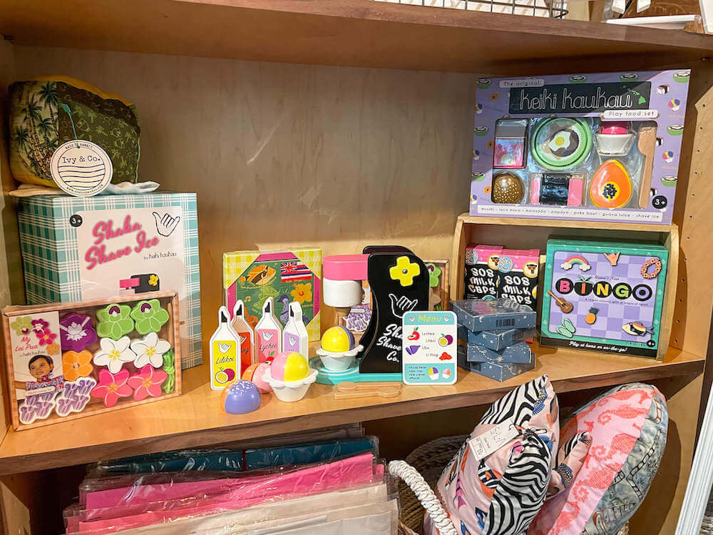 Image of a bunch of Hawaiian kids products on a shelf at Warehouse 3540 on Kauai.