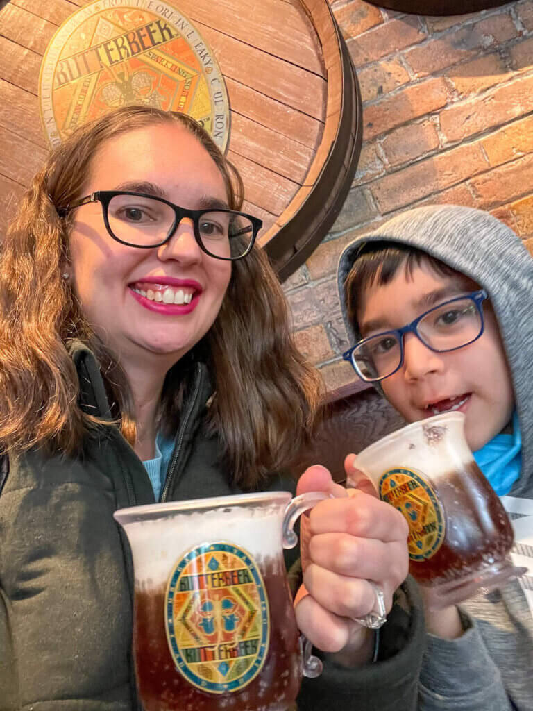 Image of a mom and son holding Butterbeer mugs at the Harry Potter store in NYC