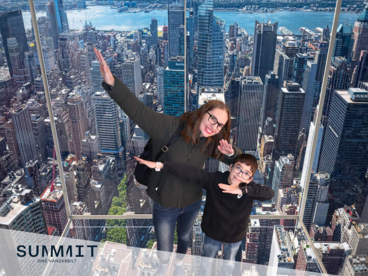 Get this kid-friendly New York in 7 days itinerary by top family travel blog Marcie in Mommyland. Image of a mom and son dabbing at Summit One Vanderbilt with NYC in the background
