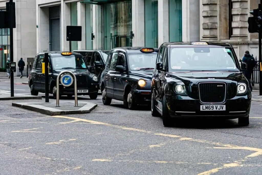 Image of a line of black cabs in London
